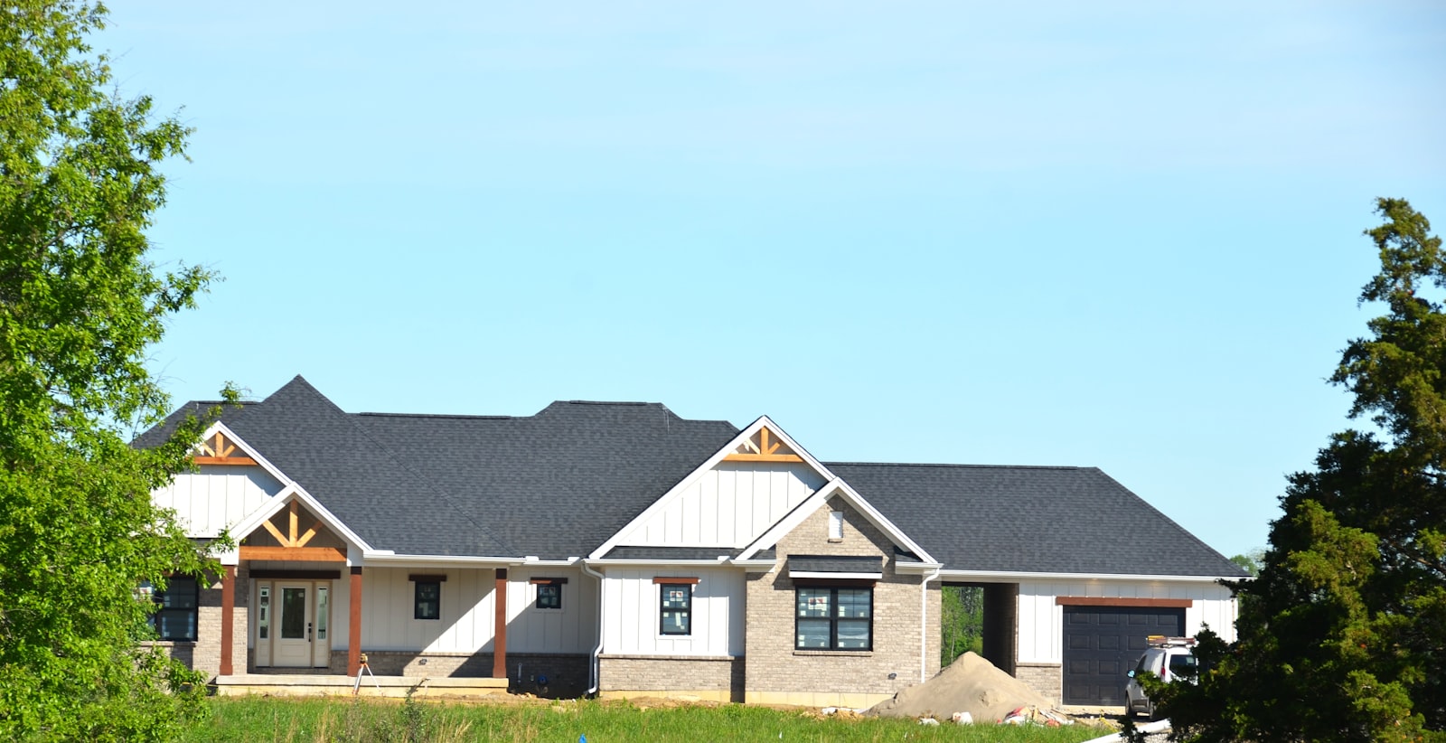 New home under construction with fresh framing and roof