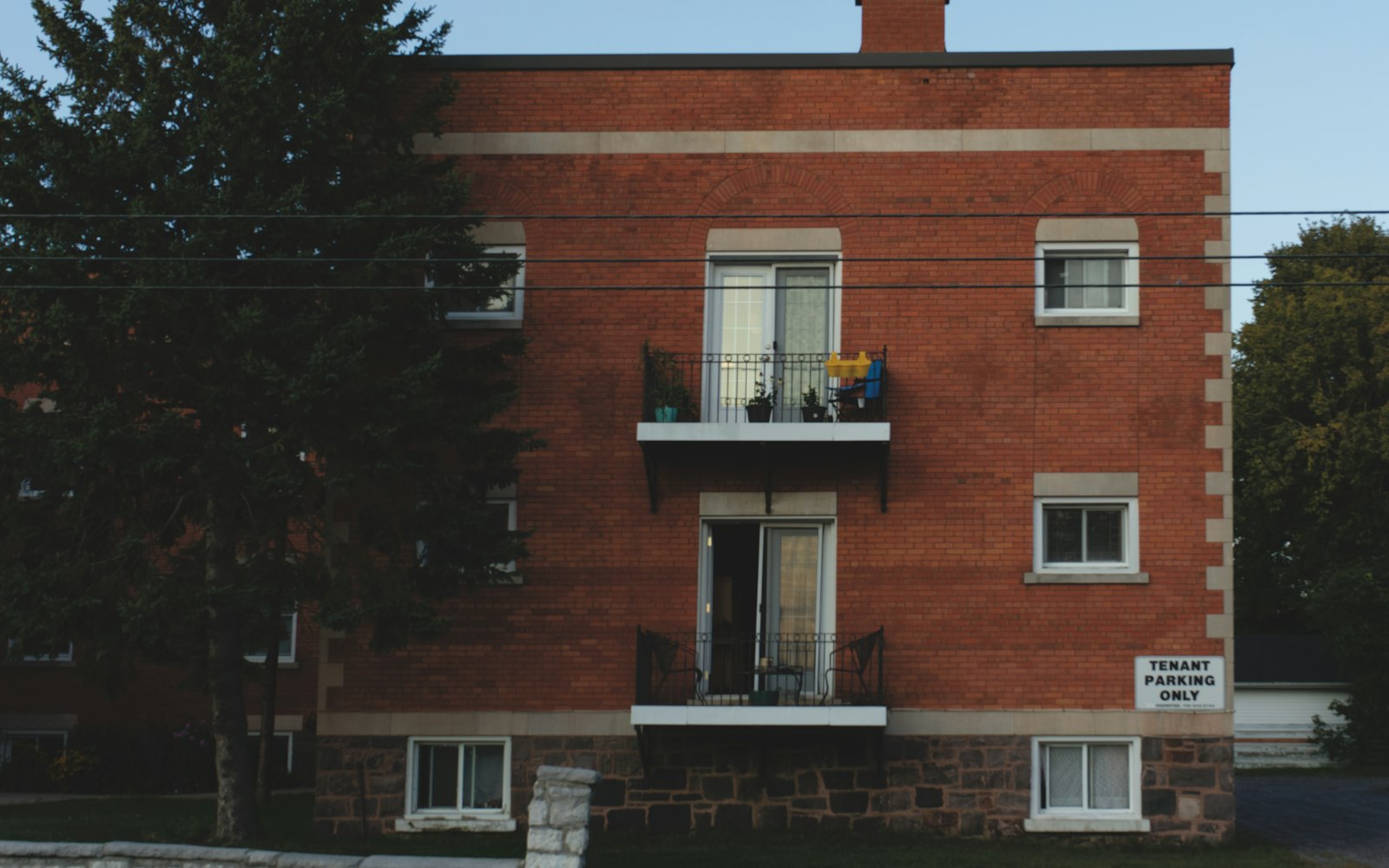 Brick apartment building among mature trees