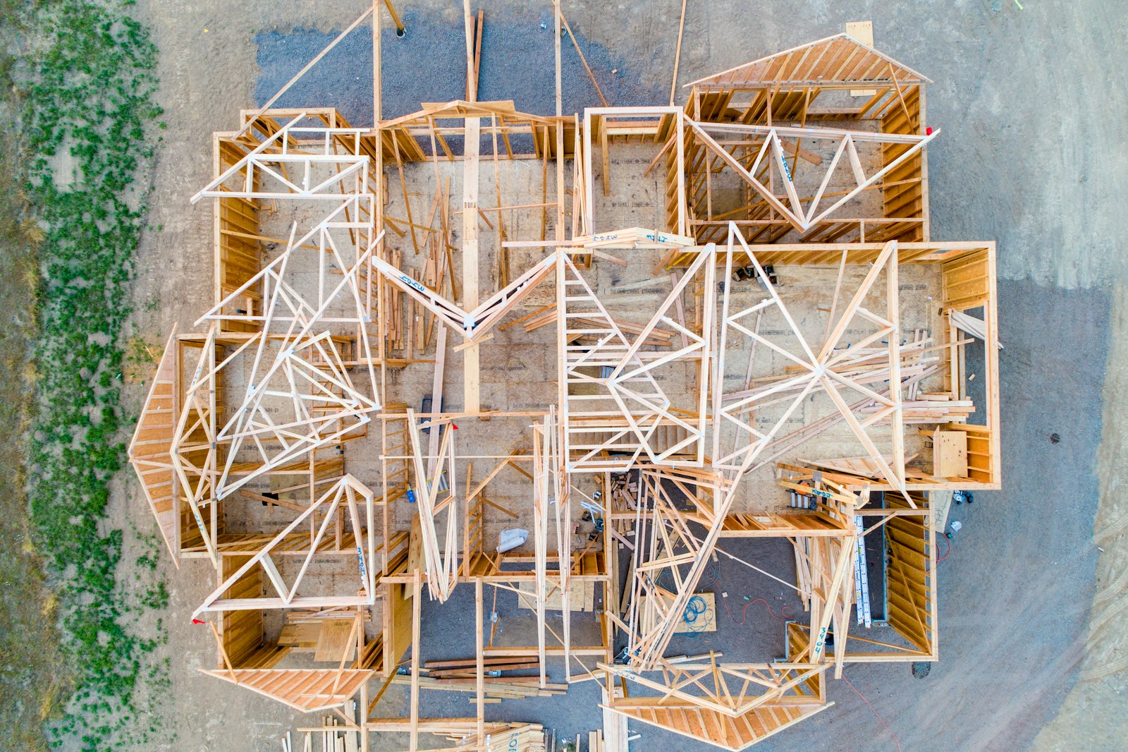 Aerial view of a house under construction, wooden framing from above